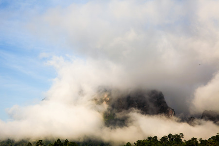 islands and mountains covered by clouds and fog in the morning of the sunny day in warm tone.の写真素材