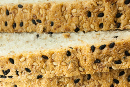 Closeup of Fresh sliced wholewheat bread with various seeds and multigrain on wood background