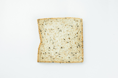 Fresh slices of wholewheat bread with various seeds and multigrain on wood backgroundの写真素材