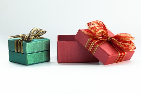Red festive gift box being opened and left on the side.の写真素材