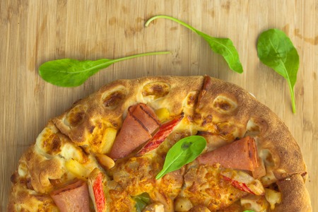 Hot Pizza Top View with Pineapple, Ham and Bell Pepperの写真素材