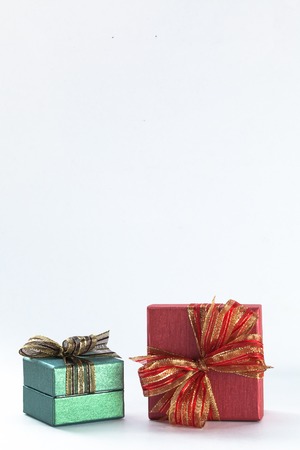 Two festive gifts being stacked up in white isolated backgroundの写真素材
