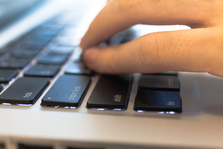 Close-up of office worker hands typing on keyboard.