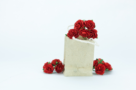Gift and red roses on white isolated backgroundの写真素材