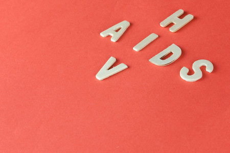 HIV and AIDS Puzzle on Red Blood Background