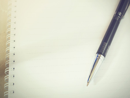 Ballpoint pen on blank sheet notebook (Vintage tone)の写真素材