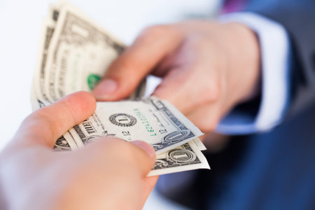 Business man giving bank notes to another person. Corruption and Payment concept