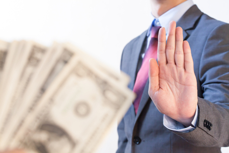 Businessman refuses to receive money - no bribery and corruption conceptの写真素材