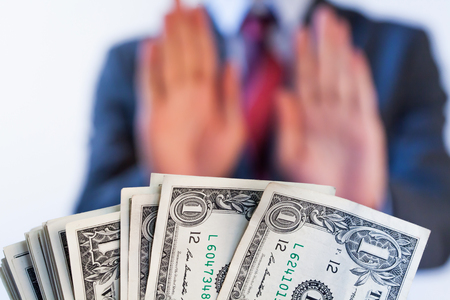 Businessman refuses to receive money - no bribery and corruption conceptの写真素材