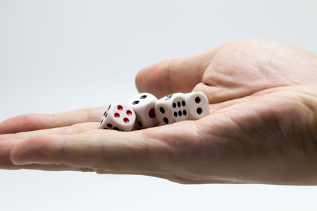 Human hand ready to roll the dice on white isolated background - Try luck, Take Risk or Business...