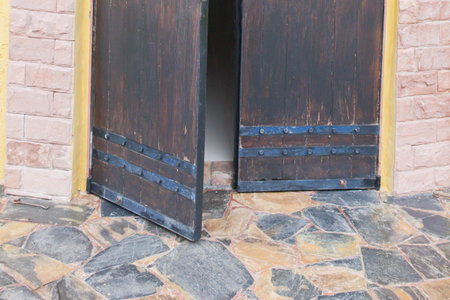 Close-up of the antique and medieval style door left opened - mystery concept.の写真素材