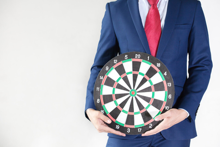 Businessman holding dartboard - business targeting, aiming, focus concept.の写真素材