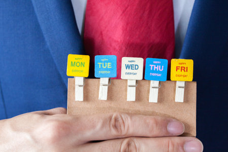Businessman holding happy working days cards - indicates every business day is happyの写真素材