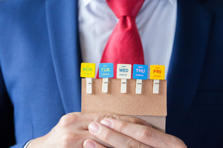 Businessman holding happy working days cards - indicates every business day is happyの写真素材