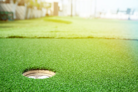Golf balls in the hole on green field.の写真素材