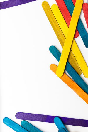 Colorful popsicle sticks over white background with copy space.の写真素材