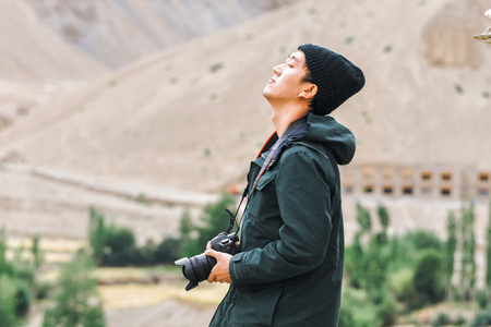 Asian travel photographer relaxing and breathing in mountain sceneの写真素材