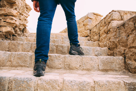 Hiker or Explorer going up on the stairs to archaeological site - Expedition and world explore.の写真素材