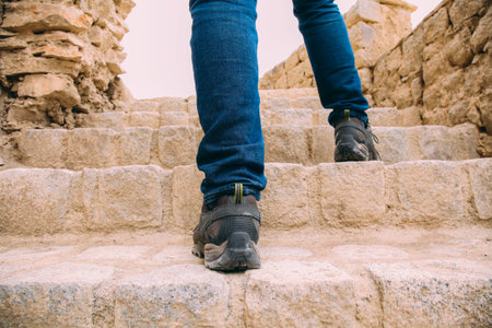 Hiker or Explorer going up on the stairs to archaeological site - Expedition and world explore.の写真素材