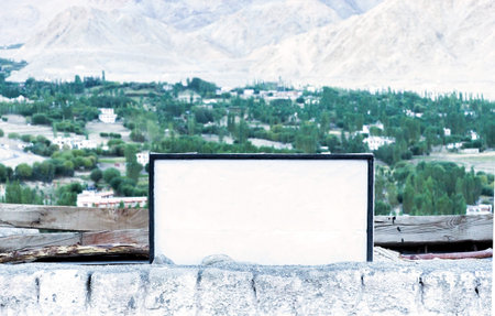 empty white signboard in mountain background - with copy space and clipping mask to advertise and...
