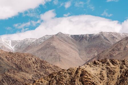 Top of rock mountain in blue cloud sky - with copyspace in Leh, Ladakh, India.の写真素材