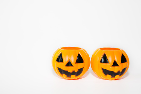 Two orange jack-o-lantern bucket pumpkins in white isolated background.の写真素材