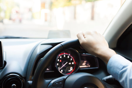 Close-up of Young man driving on the road