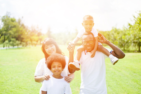 Happy family group photo in the park against sunlight.の写真素材
