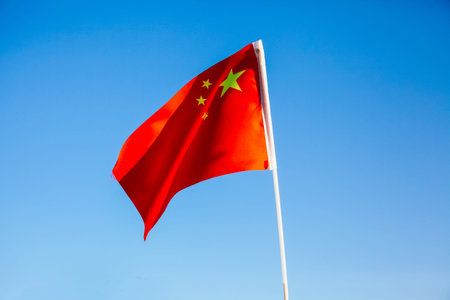China flag waving over blue sky - country in Asiaの写真素材
