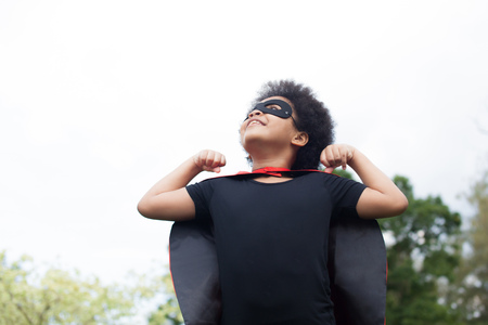 African American super hero child on flexing muscle stance - with copy spaceの写真素材