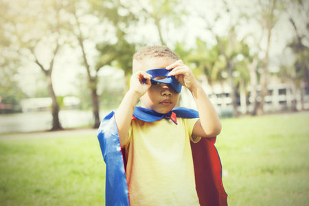 Little kid in super hero costume sneak peekingの写真素材