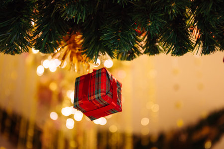 Beautiful decorated Christmas tree background with red gift box and xmas ornaments