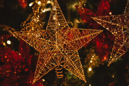 Close-up of golden Christmas detailed glittering star hanging on Christmas tree