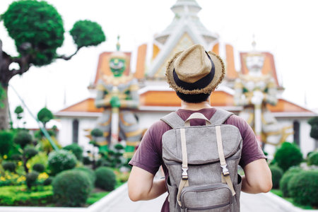 Young Asian traveling backpacker in Wat Arun in Bangkok, Thailandの写真素材
