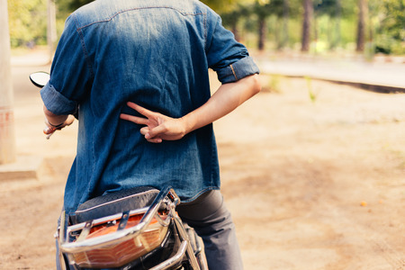 Motorcycle man riding on motorbike giving peace and safety hand signの写真素材