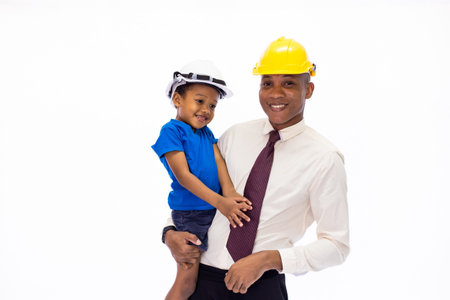 African American happy family of father and son wearing an engineering helmet together, like father like son or well education concceptの写真素材