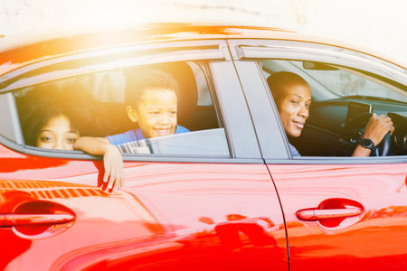 Happy and excited African American family taking a road trip with their car - Happy family togetherness conceptの写真素材