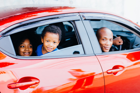 Happy and excited African American family taking a road trip with their car - Happy family togetherness conceptの写真素材