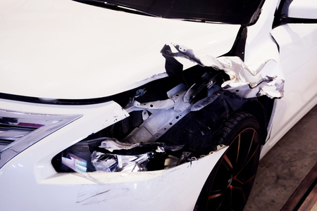 Wrecked and crashed car hit on highway  left in car garage ready to be repairedの写真素材