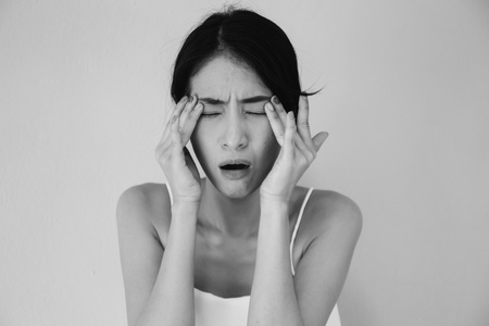 Young Asian woman having eye pain and soreness in black and white tone - Healthcare and Medical conceptの写真素材