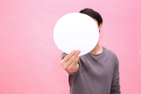 Young man showing and presenting an empty blank rounded mockup paper - with copy space to insert any textの写真素材