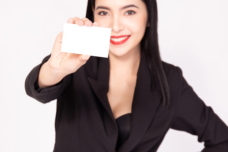 Asian happy smiling business woman in black suit holding an empty placard size paper - ready to insert commercial advertising and textの写真素材