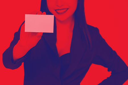 Close-up of happy smiling business woman holding an empty placard size paper - ready to insert commercial advertising and textの写真素材