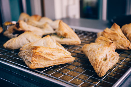 Close-up of many handmade breads on tray freshly baked from over in kitchen for commercial bakery shopの写真素材