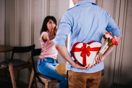 Young Asian woman rejecting and denying to receive a gift present from boyfriendの写真素材