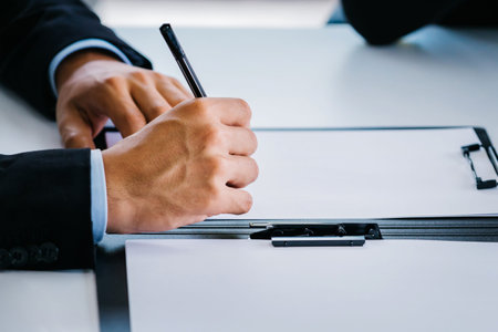 Side view of close-up executive businessman writing with pen - can be used for report, contract,...