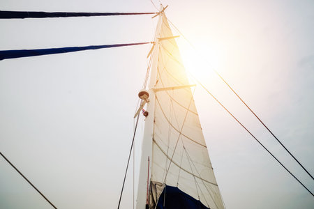 Sailing yacht boat mast from below with sun light from sky - super wide angle