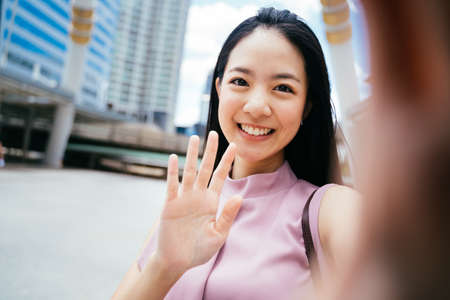 Businesswoman with black hair smiling and looking at camera, beauty, confidence, happinessの写真素材