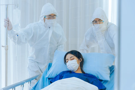Young Asian woman infected by  wearing mask under oxygen saturation treatment being taken by ...