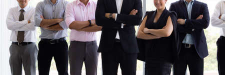 Group of confident business people in various diversity with arms crossed in corporate office setting - diverse races, genders, age.の写真素材